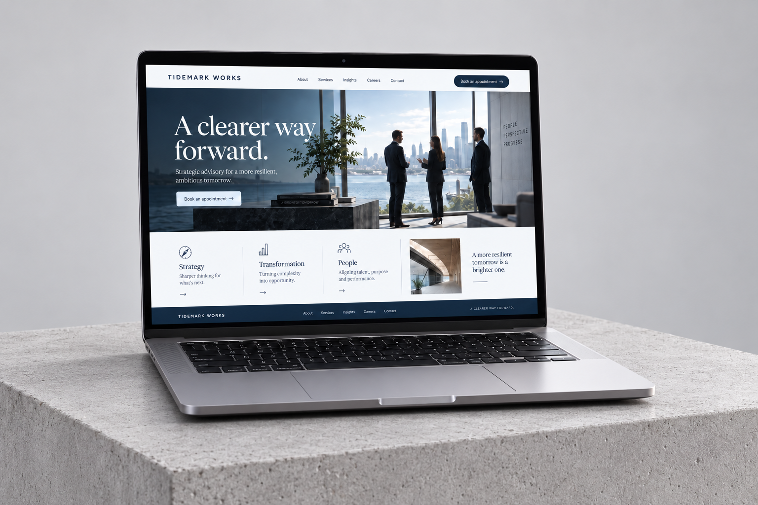 Tidemark Works landing page displayed on a MacBook on a smooth concrete block